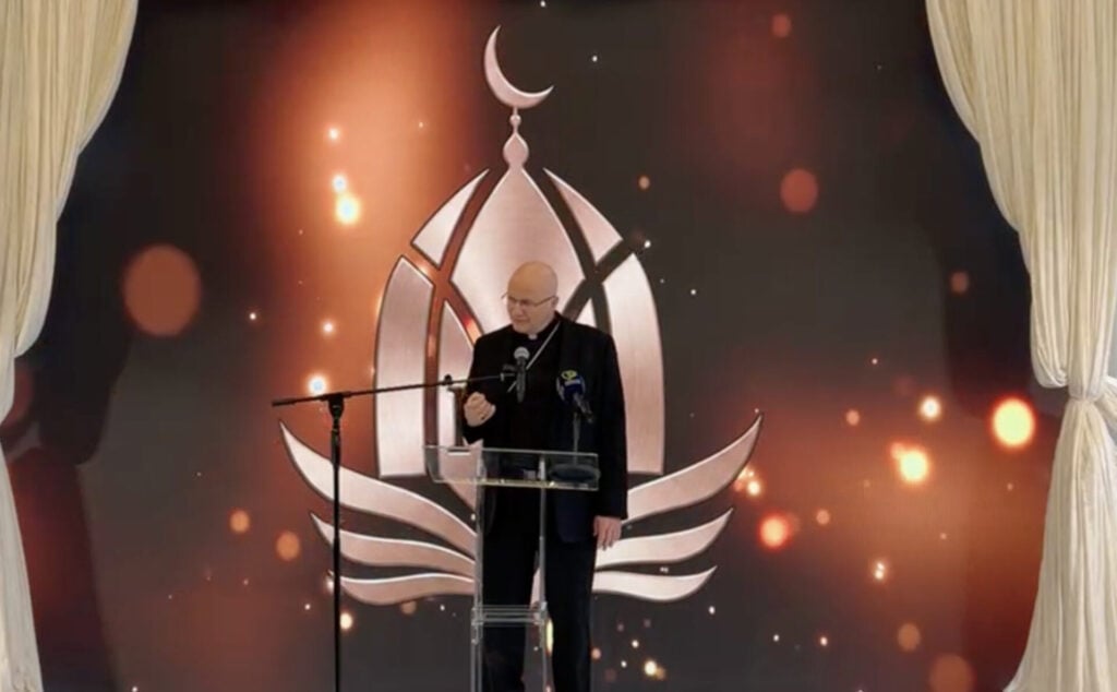 Bishop Weisenburger speaking at a Mosque.