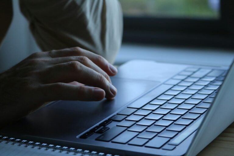 Hands typing on a computer.