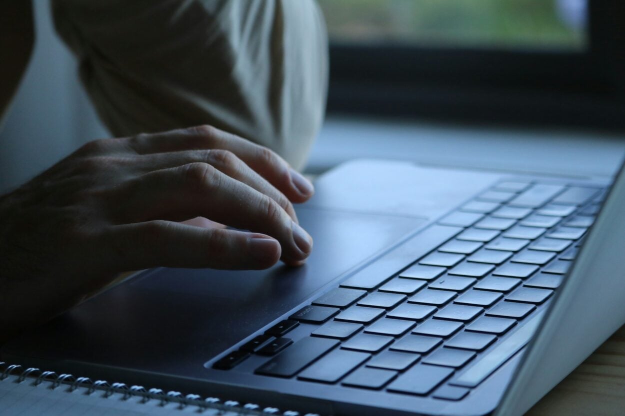 Hands typing on a computer.